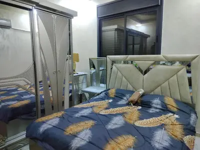 a bedroom with a bed with feathers on it at شقق مفروشه فاخره2 in Aqaba
