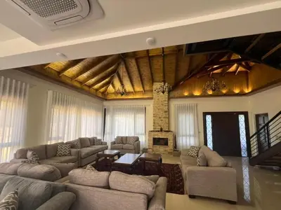 a large living room with couches and a fireplace at Bait Ajloun in Khirbat Shīn