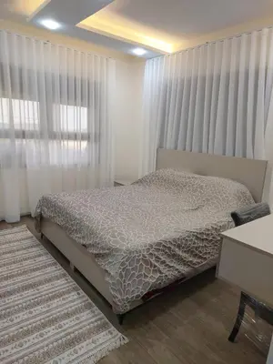 a bedroom with a bed and a window with curtains at Bait Ajloun بيت عجلون 2 in Khirbat Shīn