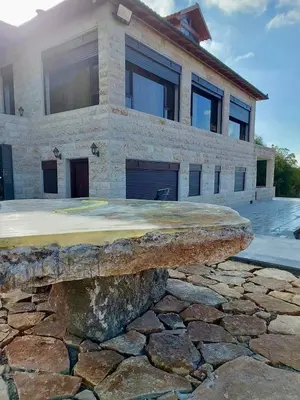 a stone bench in front of a house at Bait Ajloun بيت عجلون 2 in Khirbat Shīn