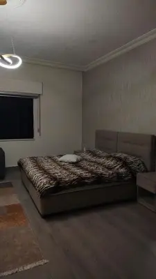 a bedroom with a large bed in a room at home 7 in Amman