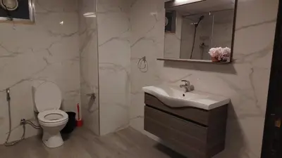 a white bathroom with a sink and a toilet at home 7 in Amman