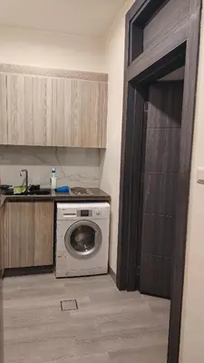 a kitchen with a washing machine in a kitchen at home 7 in Amman