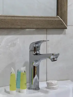 a bathroom sink with a faucet and two measuring cups at Teraa rum luxury camp in Wadi Rum