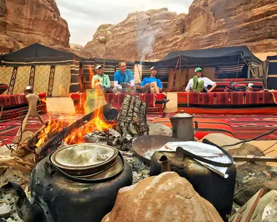 a group of people sitting around a camp fire at Teraa rum luxury camp in Wadi Rum
