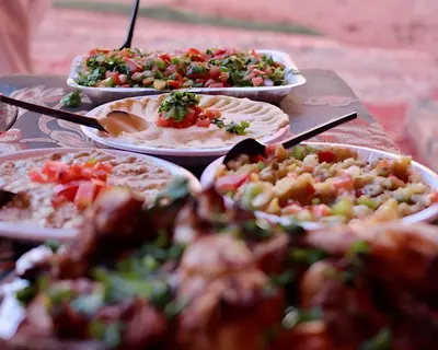 a table with several plates of food on it at Teraa rum luxury camp in Wadi Rum