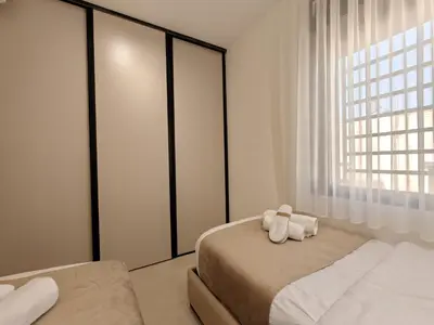 a bedroom with two beds and a window at ذا سهل ستيز in Amman