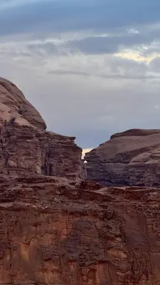 a rocky hillside with a mountain in the desert at Reef Rum Luxury Camp in Disah