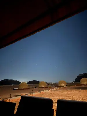 a view of a desert with domes in the background at Reef Rum Luxury Camp in Disah