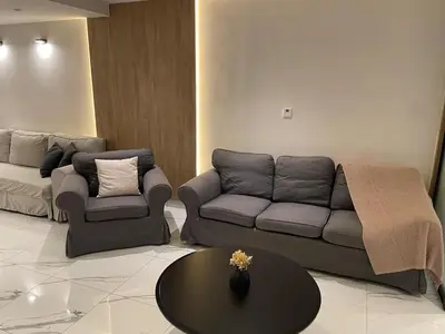 a living room with a couch and a table at Damac Towers TC1-517 in Amman