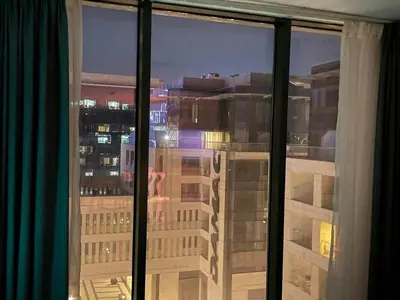 a view of a city skyline from a window at Damac Towers TC1-517 in Amman