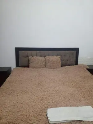 a large bed with a blanket on top of it at Flowers in Jerash