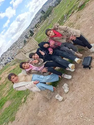 a group of people laying on a hill at Flowers in Jerash
