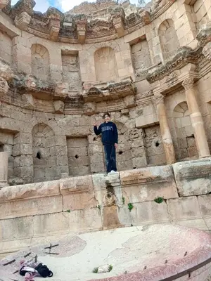 a man standing on the side of a building at Flowers in Jerash