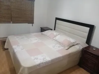 a bedroom with a large bed and two night stands at استديو للتأجير السنوي او البيع in Amman