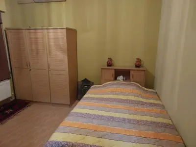 a bedroom with a bed and a dresser at استديو للتأجير السنوي او البيع in Amman