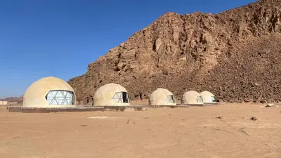 a group of domes in front of a mountain at Fortuna Rum Bubble Hotel & Jeep Tours in Wadi Rum