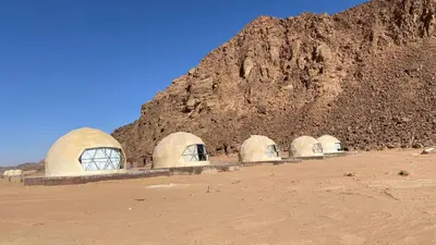 a group of domes in front of a mountain at Fortuna Rum Bubble Hotel & Jeep Tours in Wadi Rum