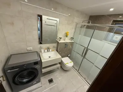 a bathroom with a washing machine and a washer at شقة مميزة في عبدون -Special apartment in Abdon in Amman