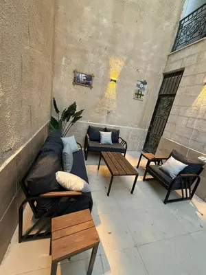 a patio with couches and tables in a building at شقة مميزة في عبدون -Special apartment in Abdon in Amman