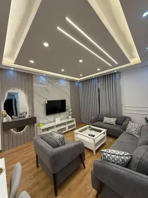 a living room with two couches and a tv at شقة مميزة في عبدون -Special apartment in Abdon in Amman