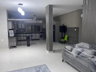 a living room with a bed and a kitchen at jordanien madaba in Madaba