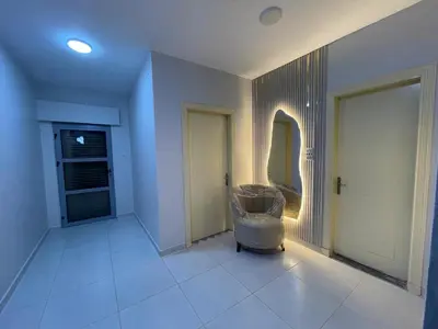 a room with a hallway with a door and a mirror at apartement khaled in Madaba