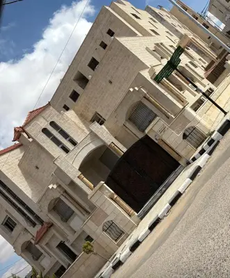 a tall building with a large window on the side of it at apartement khaled in Madaba
