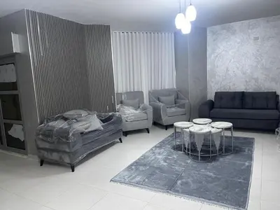 a living room with a couch and a table and chairs at apartement khaled in Madaba