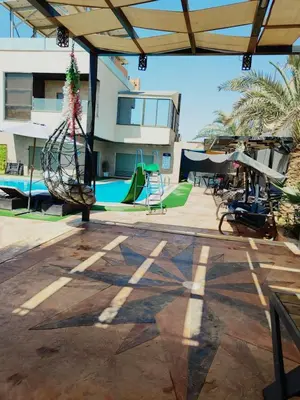 a patio with a playground with a swing at The Amazing View chalet in Al Rama