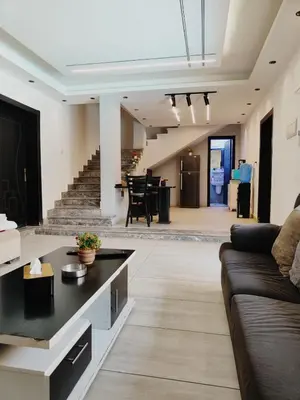 a living room with a couch and a table at The Amazing View chalet in Al Rama
