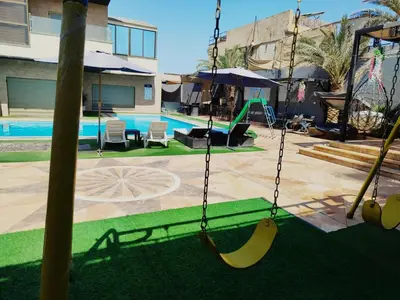 a swing with bananas on it in a pool at The Amazing View chalet in Al Rama