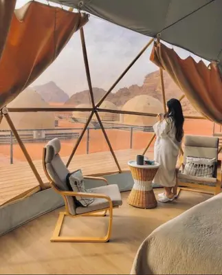 a woman taking a picture of a view from a room at The Heritage Inn in Disah