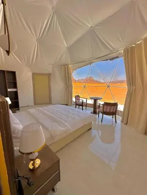 a bedroom with a large bed with a view of the desert at The Heritage Inn in Disah