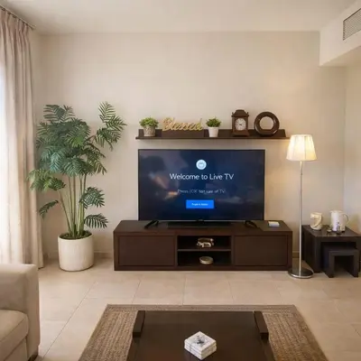 a living room with a flat screen tv at Abdoun Elite Residence Stunning View in Amman