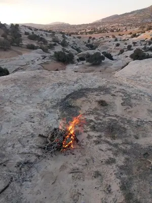 a campfire in the middle of a desert at Night in Dana in Dana