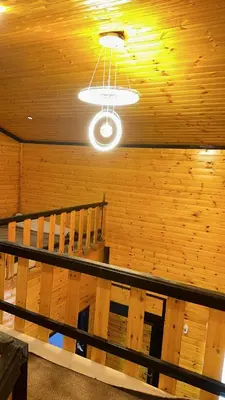 a ceiling with a light in a room with wooden walls at Akwakh Al-Kanz Huts Ajloun Jor in Ajloun