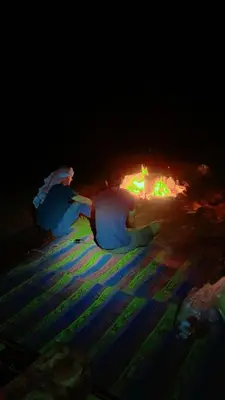 a group of people sitting on top of a birthday cake at Wadi Rum, Mars Cave in Wadi Rum