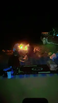 a table in the dark with a truck in the background at Wadi Rum, Mars Cave in Wadi Rum