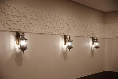 a wall with three lights on it with lights on it at saraya stays premium in Amman