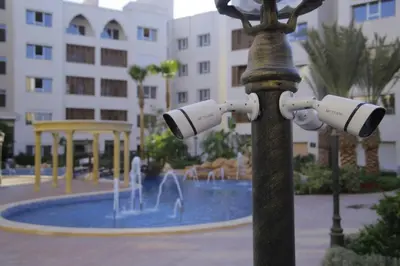 a light pole with cameras on it in front of a fountain at saraya stays premium in Amman