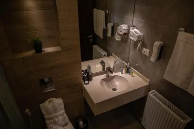 a bathroom with a sink and a mirror at saraya stays premium in Amman