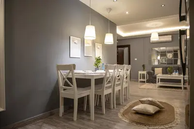 a dining room with a white table and chairs at saraya stays premium in Amman