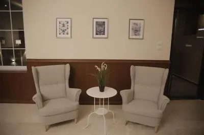 two chairs and a table in a room at saraya stays premium in Amman