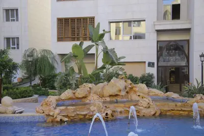 a water fountain in front of a building at saraya stays premium in Amman