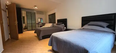 a hotel room with two beds and a bathroom at شقة مفروشة فاخرة in Amman