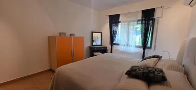 a bedroom with a bed and a dresser and a window at شقة مفروشة فاخرة in Amman
