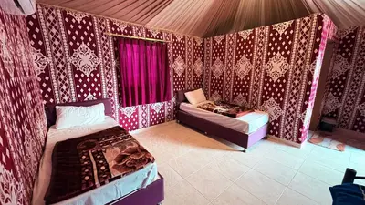 a room with two beds and a couch in it at Silent Dunes Camp in Disah