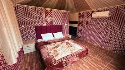 a bedroom with a bed in a tent at Silent Dunes Camp in Disah