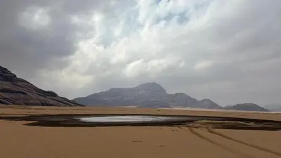 a view of a beach with mountains in the background at Your Bedouin family home in Disah